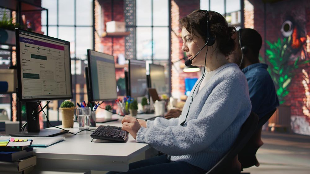 Customer service specialist wearing a headset working at her desk