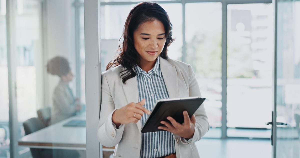 Woman reviewing information on a tablet in an office
