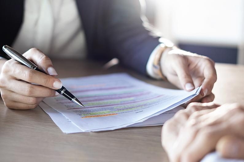 Team reviewing charts and reports on a table