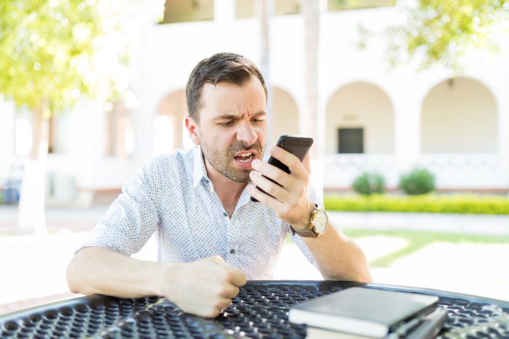 Frustrated user struggling with his mobile banking app