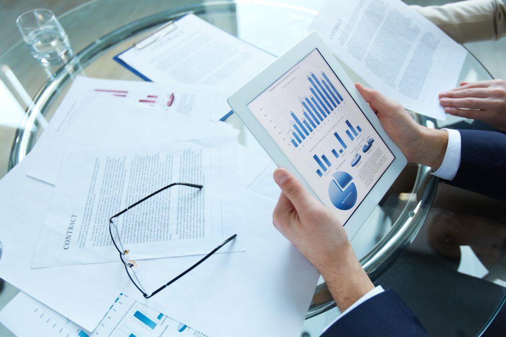 Reviewing financial charts and data on a tablet