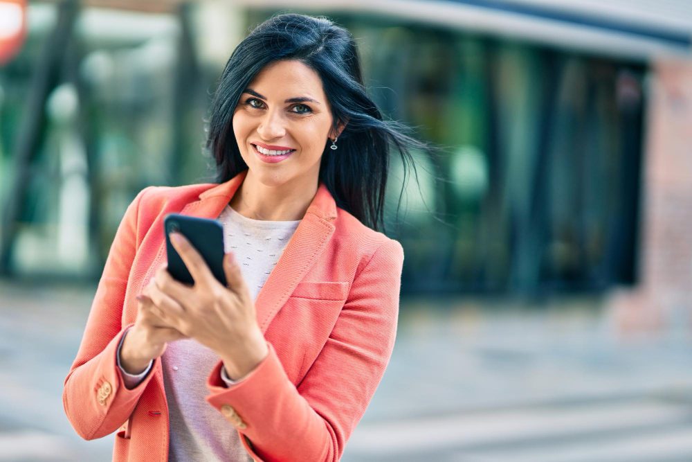 Woman smiling while checking her mobile banking app