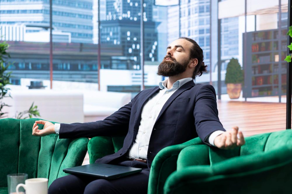 Relaxed professional sitting confidently in an office lounge
